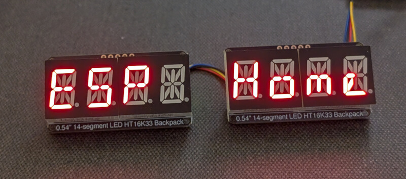 A picture of two HT16k33 based displays displaying the phrase 'ESP Home'